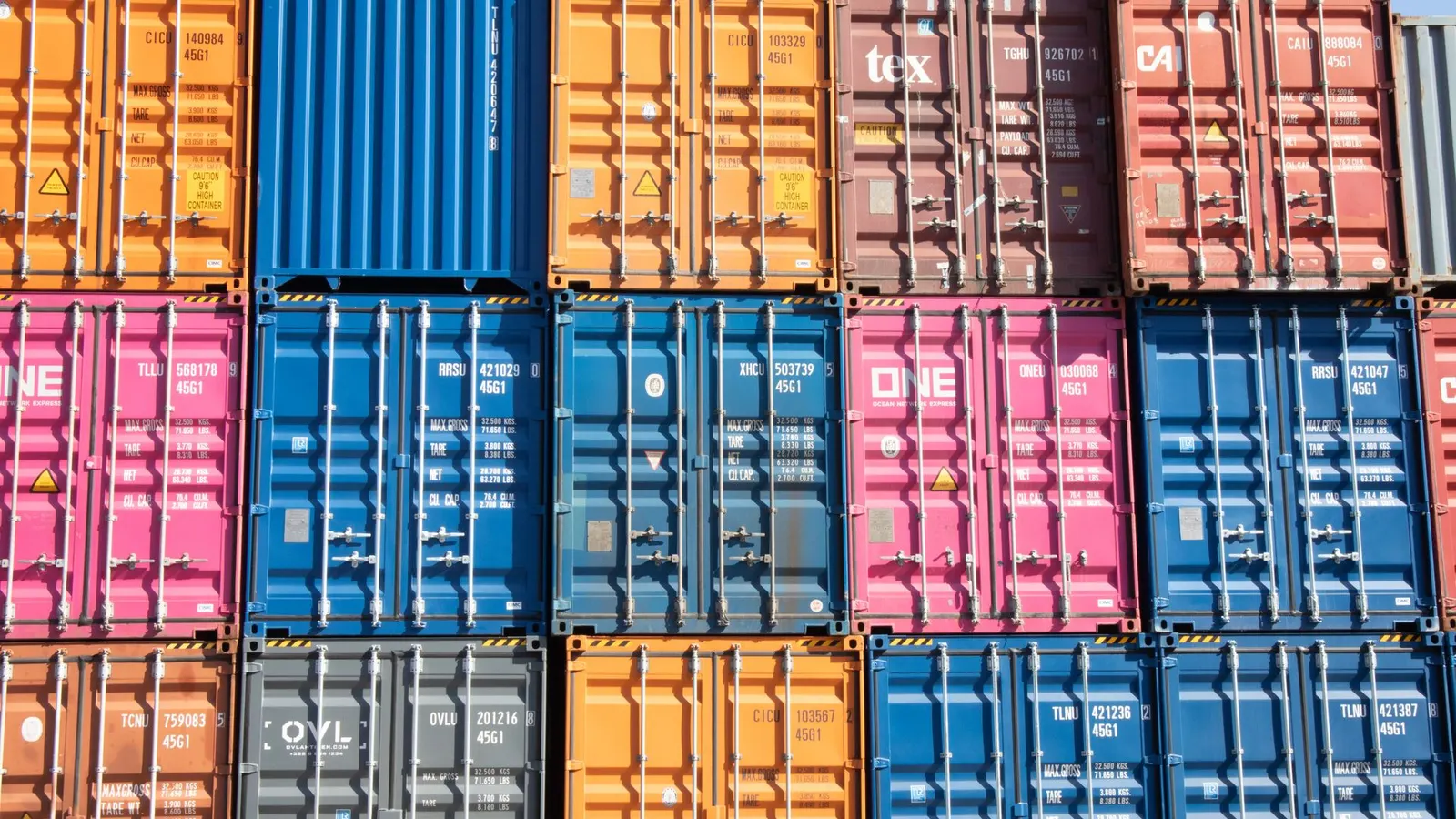 A wall of stacked shipping containers in many colours
