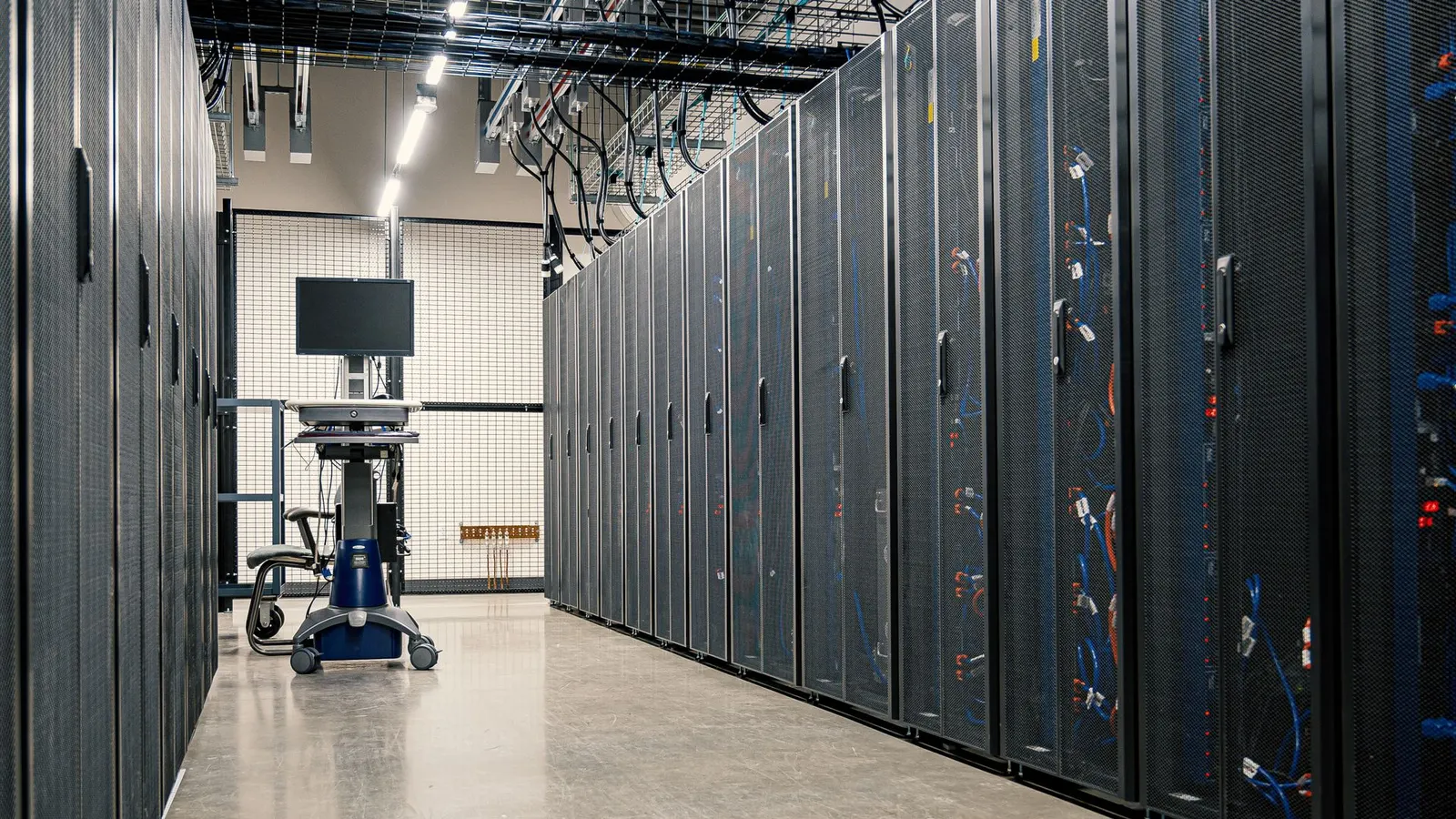A data centre corridor with rows of server racks